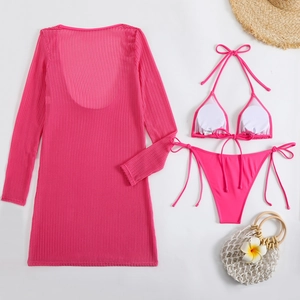 Flat lay of pink 3-piece bikini set with mesh cover-up dress and summer beach accessories