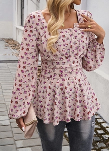 Close-up of elegant puff sleeves and floral pattern on a square neck peplum top