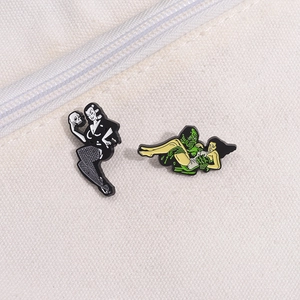 Retro gothic enamel pins set featuring a pinup skull lady and a classic green lagoon monster