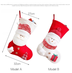 Detail view of large knit Christmas stockings with Santa and Snowman designs