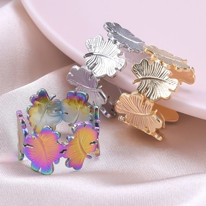 Retro stainless steel leaf rings in rainbow, silver and gold finishes on pink silk