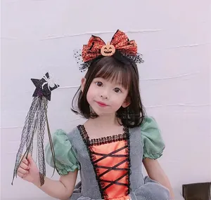 Girl in Halloween pumpkin dress with mesh headband and spider star magic wand detail