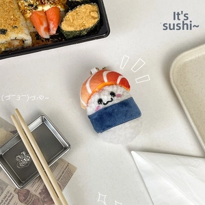 Detail of cute salmon sushi plush keychain with soft rice texture and embroidery