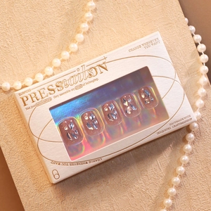 Sparkly pink press-on nails with crystals and blue stones in a premium gift box