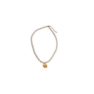 Elegant pearl necklace with golden heart pendant and adjustable clasp on white background
