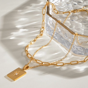 Gold double-layer stainless steel necklace featuring a star engraved square pendant