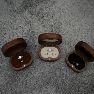 Detailed overhead view of oval walnut wood jewelry boxes with plush velvet lining