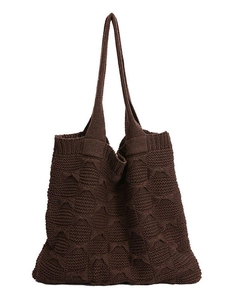 Deep brown knit tote bag with chunky texture and long shoulder straps on white background