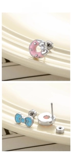 Detail of pink donut and blue bow cartilage earrings with secure screw back closure