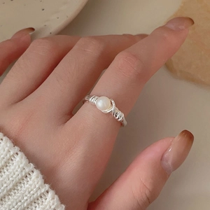 Elegant 925 sterling silver pearl ring with delicate wire-wrap band on finger