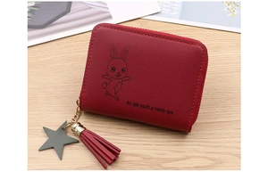 Close-up of red PU leather coin purse with tassel, star charm and cartoon rabbit print