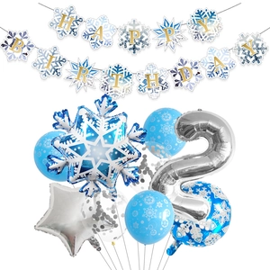 Detail of blue and silver snowflake party set with foil balloons and happy birthday banner