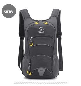Detail of grey outdoor backpack showing durable nylon fabric and yellow zipper pulls