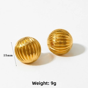 Detailed view of 15mm gold sphere earrings featuring vertical textured stripes and polished finish