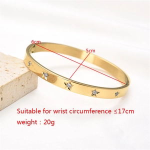 Detailed view of gold stainless steel star bangle with crystals and inner diameter measurements