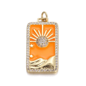 Macro shot of gold rectangle sun pendant with orange enamel and crystal stones