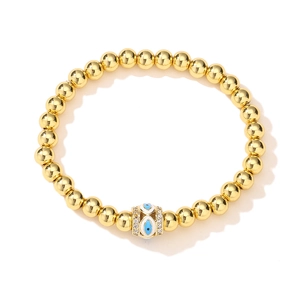 Detail view of 18K gold plated bead bracelet with blue evil eye and zircon accents