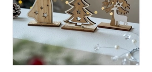 Macro detail of wooden Christmas tree ornaments featuring reindeer silhouette and star bell