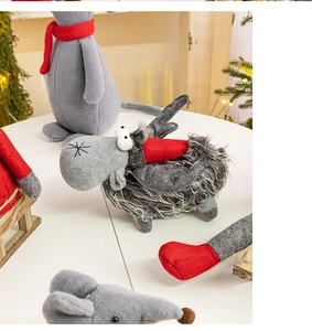 Detailed close-up of Christmas gnome plush doll with red knit scarf and soft fur texture