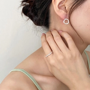 Minimalist S925 sterling silver triple hoop earrings and beaded ring on a model