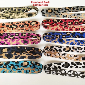 Front and back comparison of leopard print woven bag straps with metal hooks