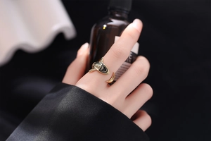 Detail of creative gold shark opening ring worn on finger with minimalist aesthetic