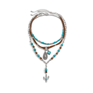 Detail of bohemian layered necklace featuring turquoise beads and silver cactus pendant
