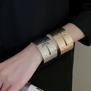 Vue détaillée d'un large bracelet manchette martelé avec découpe de croix évidée