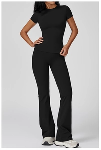 Close-up of black slimming short-sleeve top and flared yoga pants with premium matte fabric