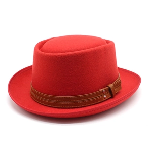 Red wool pork pie hat with a brown leather buckle band in a classic British vintage style