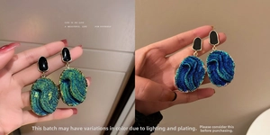 Detail of vintage teardrop earrings with emerald green and sapphire blue iridescent resin