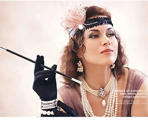 Close-up of 1920s pink feather headband and multi-layer pearl necklace on a female model