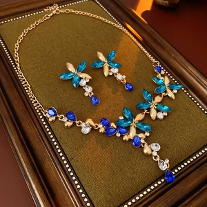 Detail of vintage flower jewelry set with blue crystals and water drop earrings
