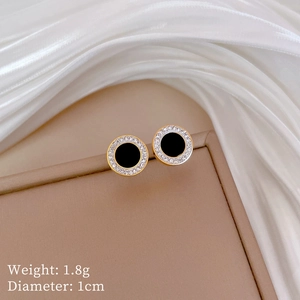 Detailed shot of gold-plated onyx stud earrings with cubic zirconia and size specifications