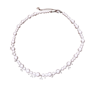 Elegant pearl necklace with star pendants, heart tag and adjustable silver clasp on white