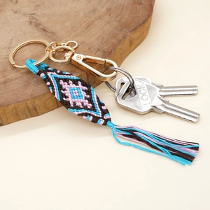 Handmade woven evil eye keychain with colorful diamond pattern and tassel fringe pendant