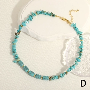 Detailed macro view of turquoise irregular stone necklace with gold lobster clasp and chain