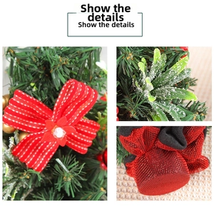 Detail of a red polka dot bow, snow-dusted pine needles, and a red glitter mesh ornament