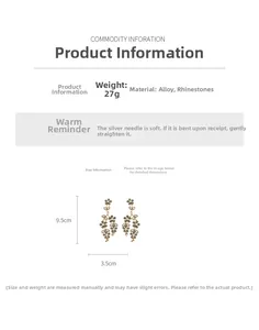 Detailed view of vintage gold floral drop earrings with green and white rhinestones