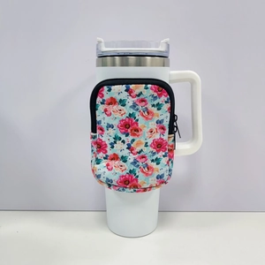 Detailed view of white tumbler with floral zipper pouch and secure ergonomic handle