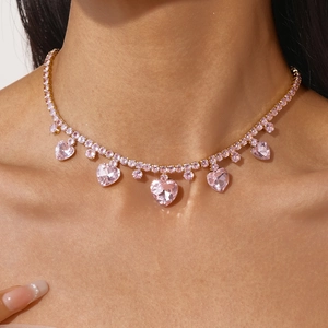 Detailed close-up of a luxury gold-plated necklace featuring pink heart-shaped zircon pendants