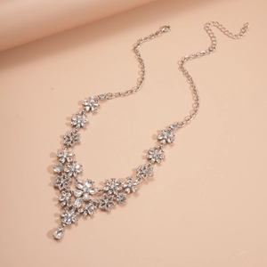 Detailed view of silver flower necklace with sparkling rhinestones and teardrop pendant