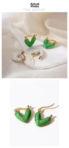 Detail of gold titanium steel heart earrings in emerald green and pearl white enamel