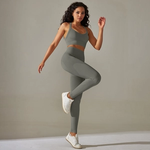 Close-up of seamless knitted grey-green yoga set with high waist and ribbed texture