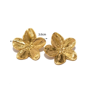 Detailed view of 3.0cm golden flower earrings with textured radial brushed metal petals