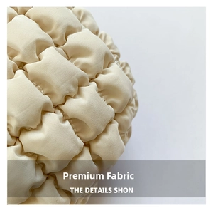 Macro shot of the off-white quilted bubble fabric detail on the nylon hobo handbag