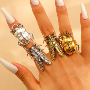 Detailed close-up of retro beetle and cicada insect rings with antique metal finish