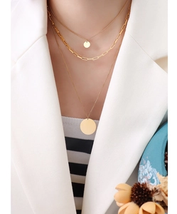 Detailed view of triple-layered 18K gold-plated paperclip necklace on a model