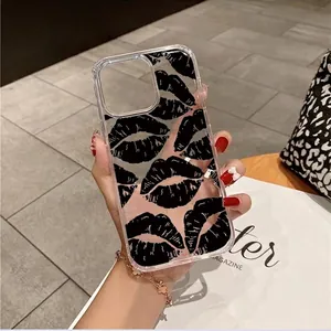 Transparent iPhone case with vintage black lip pattern held in hand against stylish background