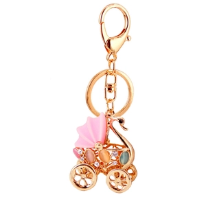Sparkling rhinestone swan stroller keychain with colorful cat eye stones on a gold base